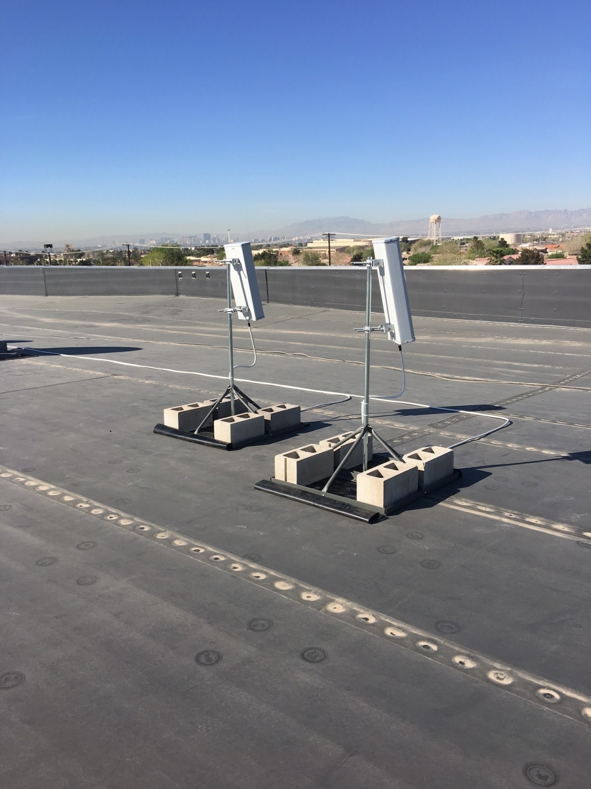 Pair of sector antennas installed on roof of building. Dual antennas ensures a good lock on the azimuth for the carriers that need to be supported.